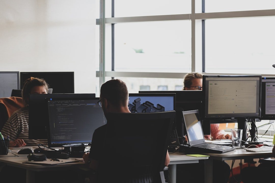 people-sitting-on-chair-in-front-of-computer-monitor-fa9b57hffnm